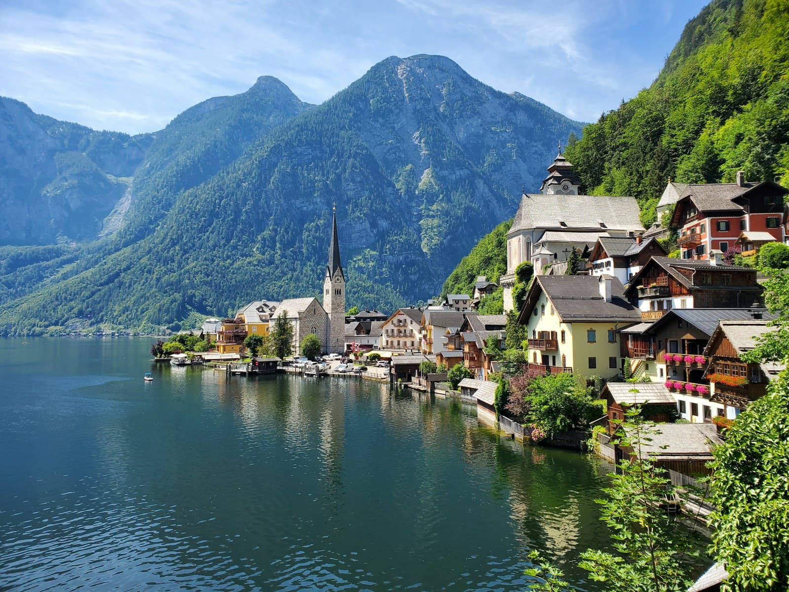 Hallstatt village and church spire on the lakeshore beneath the Austrian Alps