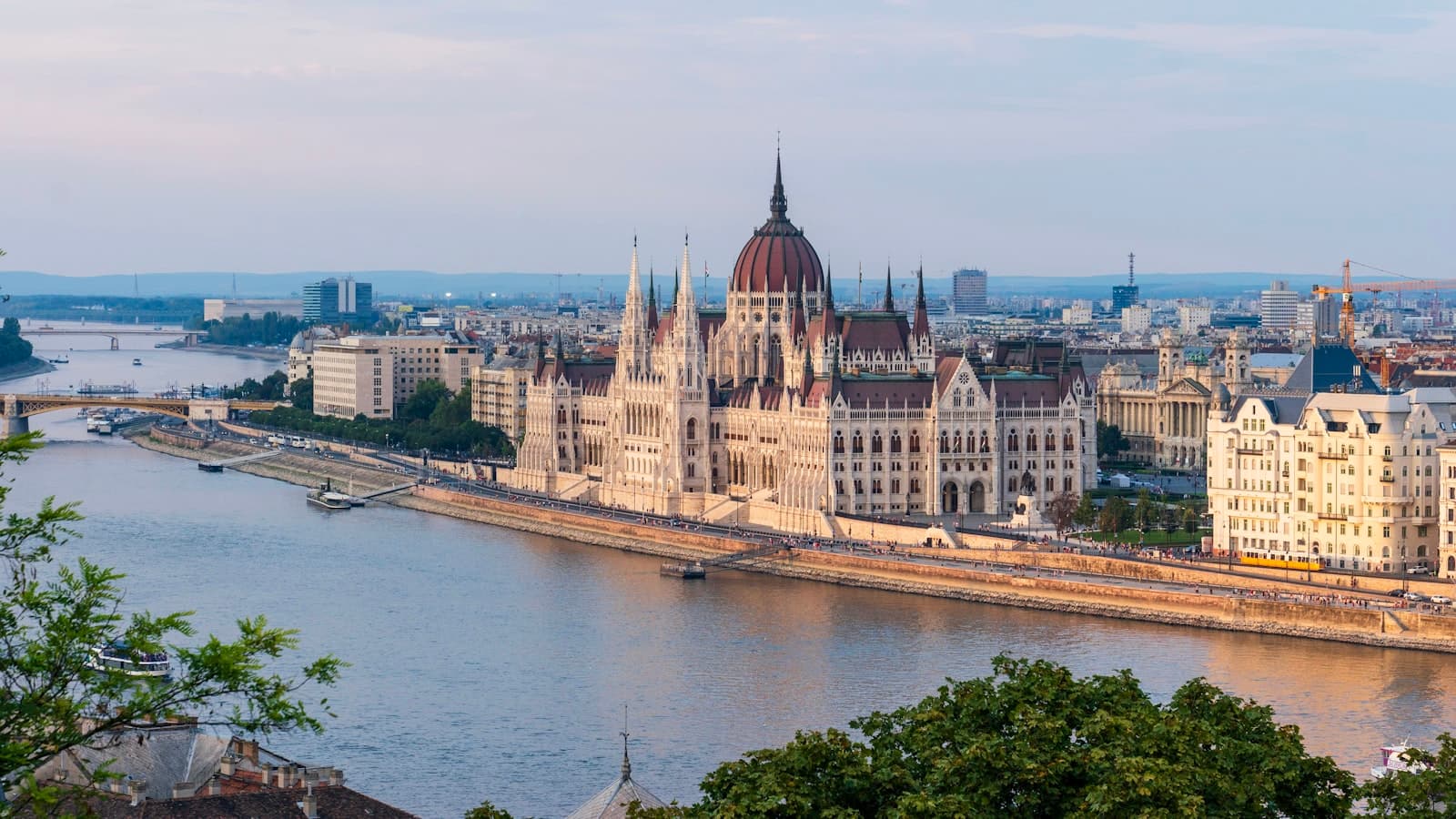 Hungarian Parliament Building on the Danube riverbank in Budapest at golden hour