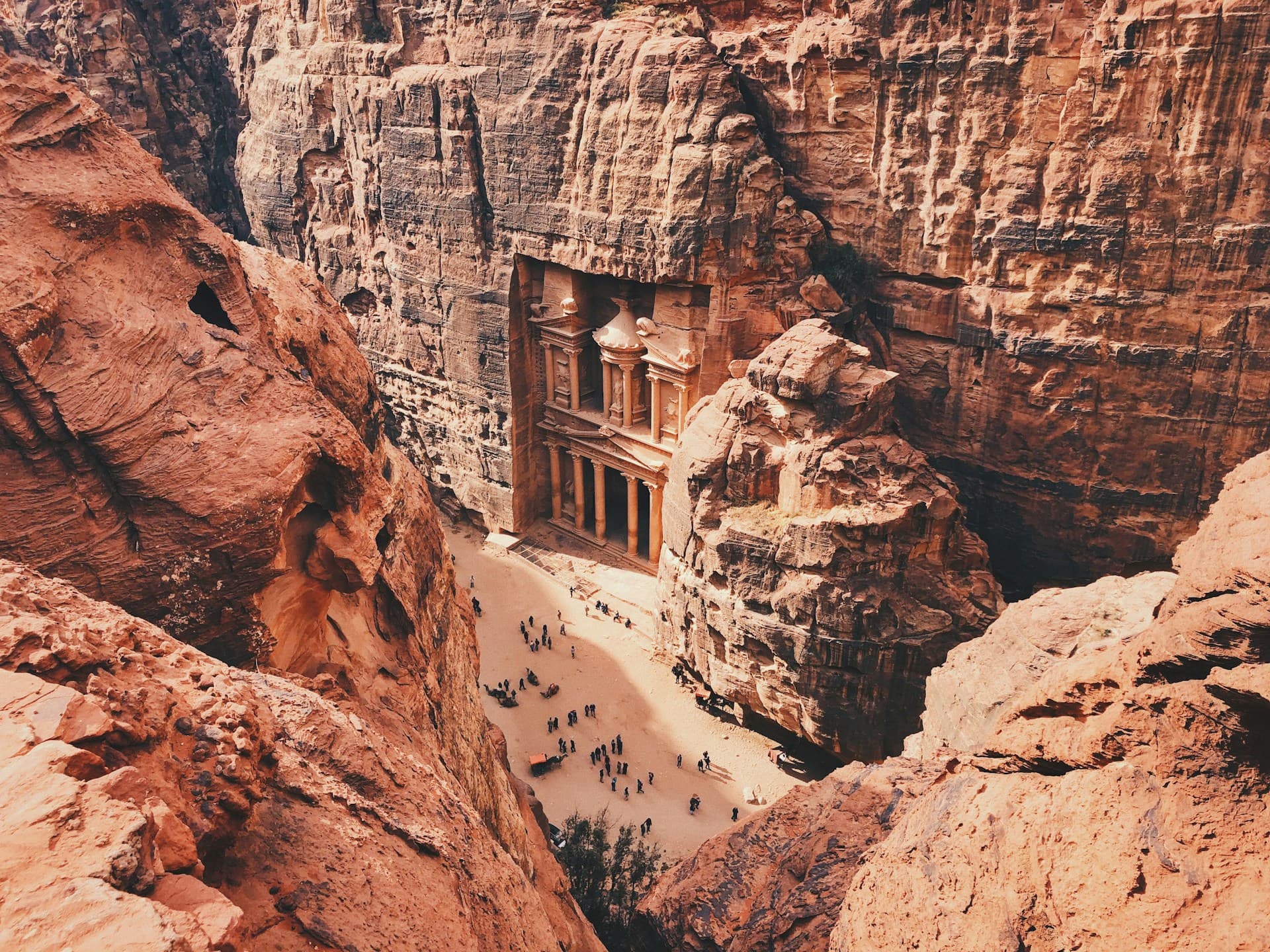 The Treasury (Al-Khazneh) at Petra glowing in golden sunlight at the end of the Siq