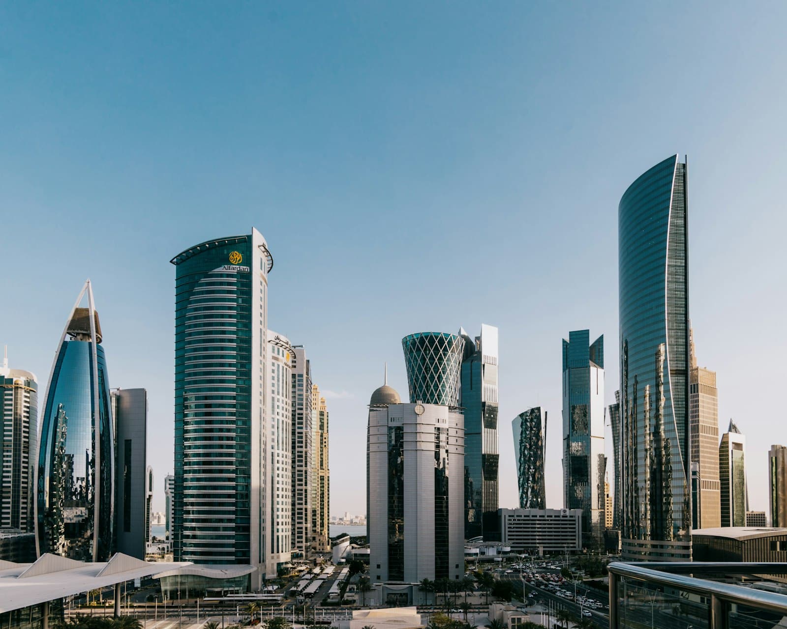 Glass skyscrapers of Doha's West Bay skyline under a clear sky