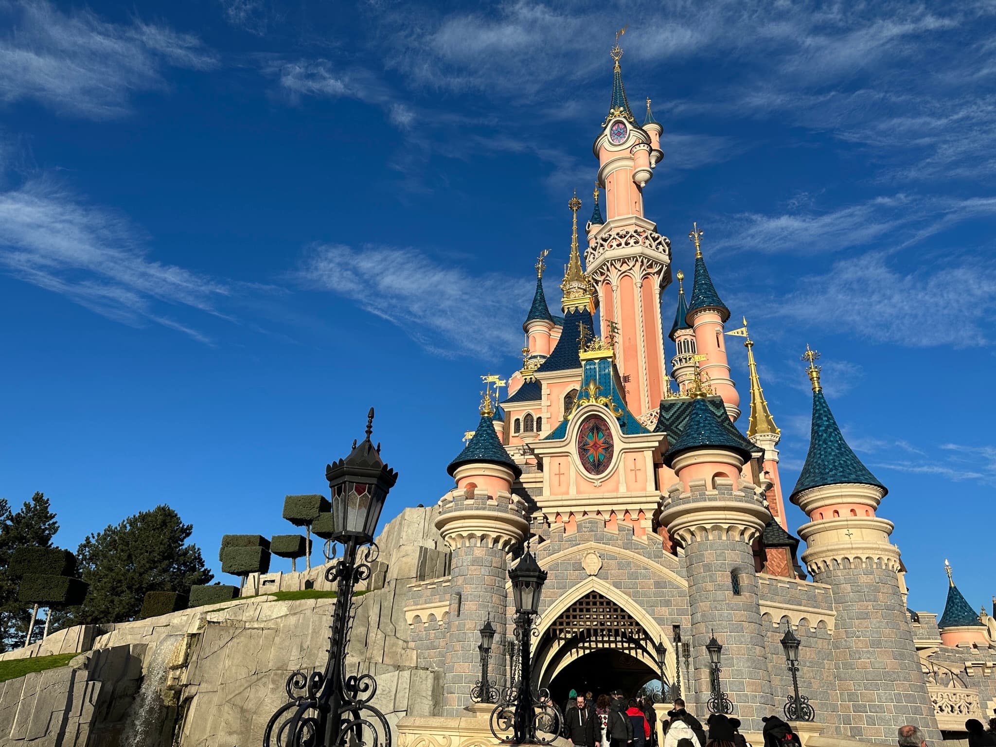 Sleeping Beauty Castle at Disneyland Paris against a blue sky
