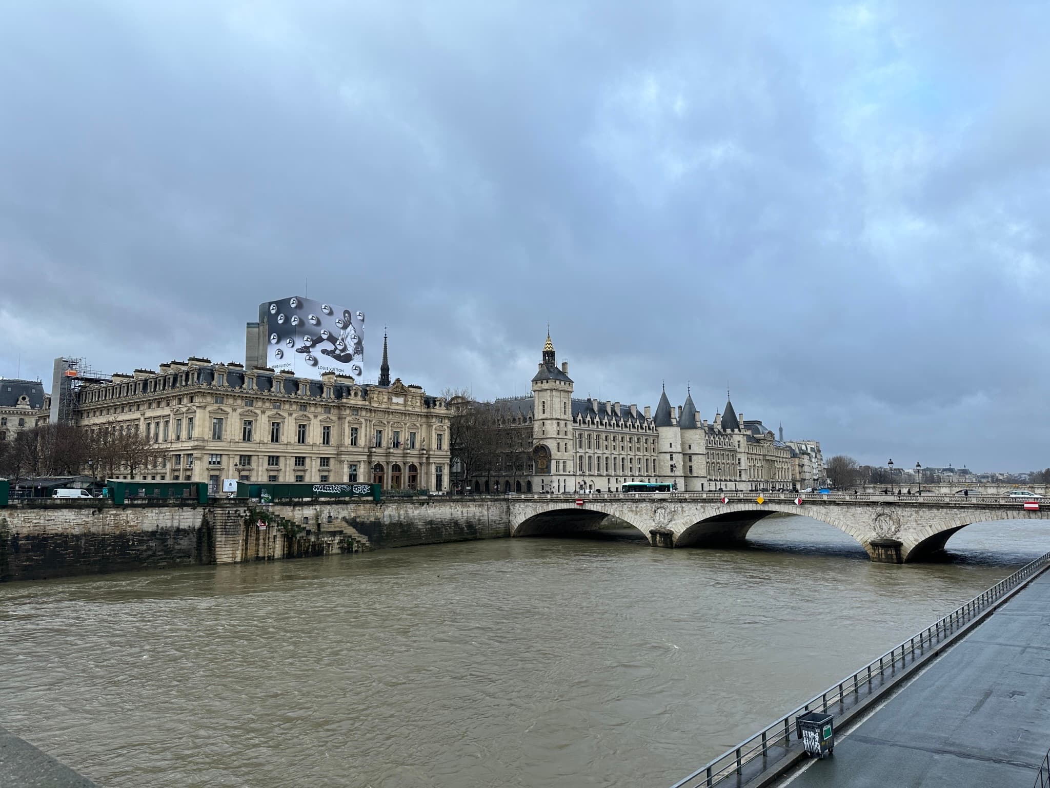 View along the Seine River toward the Conciergerie and Pont au Change on a moody winter day in Paris